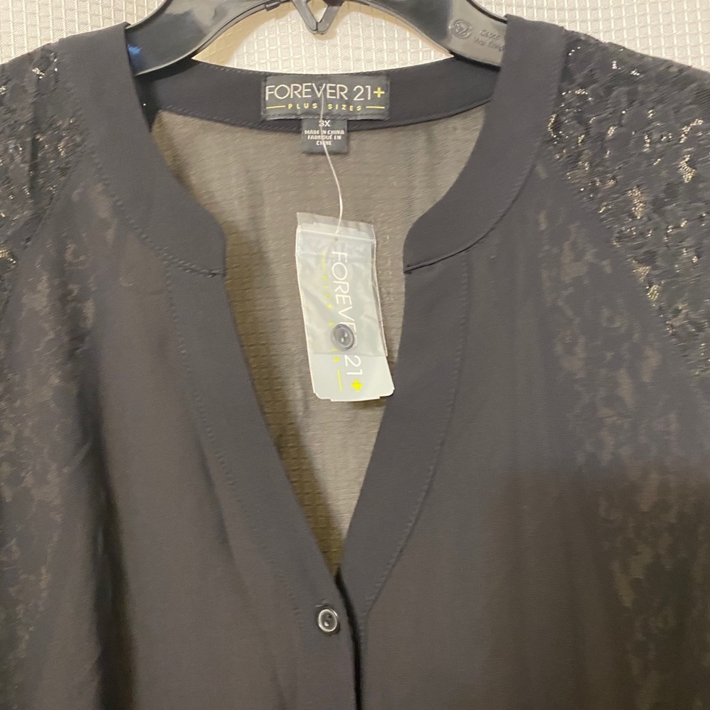 Black top with lace accent. Long sleeve.